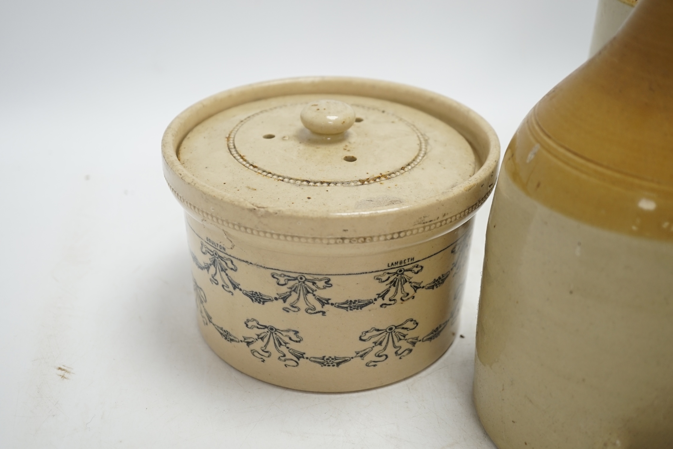 A late Victorian Doulton Lambeth Sanitary Fountain feeder, another similar, and a circular jar and cover, sanitary feeder 25cm high. Condition - sanitary feeder good, other feeder chipped and cover to jar chipped